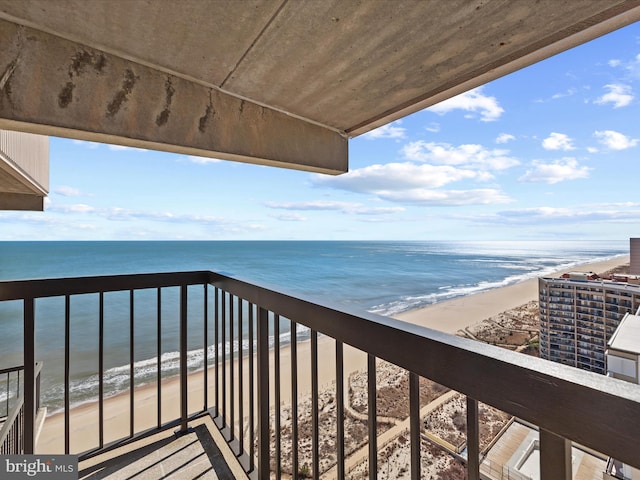 balcony with a view of the beach and a water view