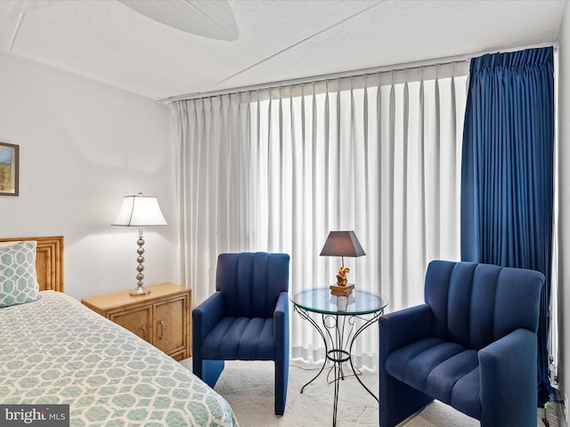 bedroom featuring a textured ceiling and light carpet