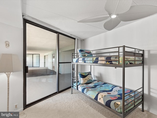 bedroom featuring multiple windows, floor to ceiling windows, and carpet flooring