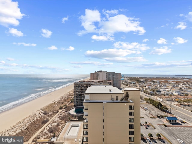 birds eye view of property featuring a beach view and a water view