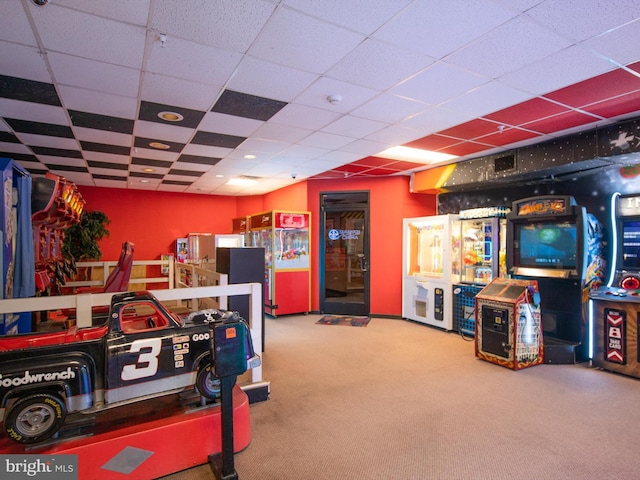 recreation room featuring carpet and a drop ceiling