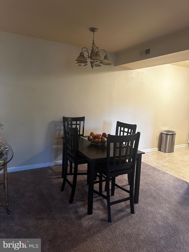 dining area featuring baseboards, carpet floors, visible vents, and a notable chandelier