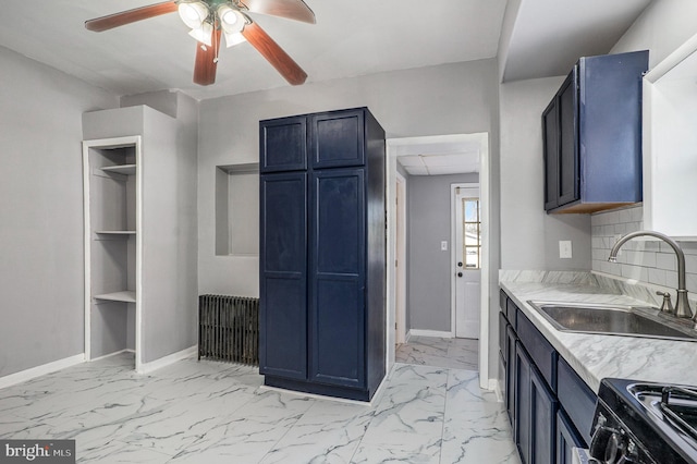 kitchen with black range with electric cooktop, baseboards, marble finish floor, and a sink