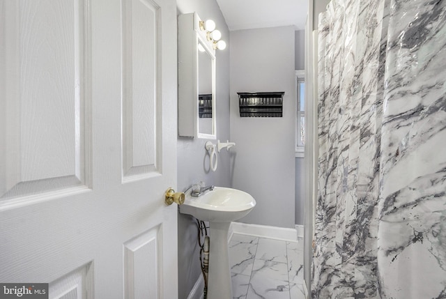 bathroom featuring baseboards and marble finish floor