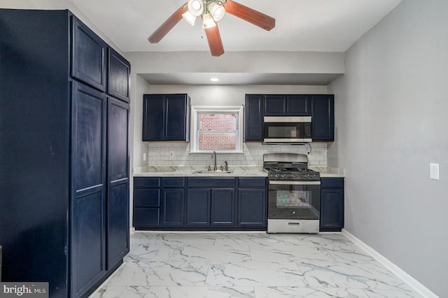 kitchen with baseboards, light countertops, marble finish floor, stainless steel appliances, and a sink