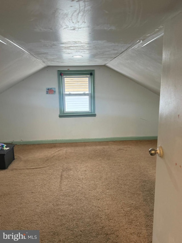 bonus room featuring carpet floors and vaulted ceiling