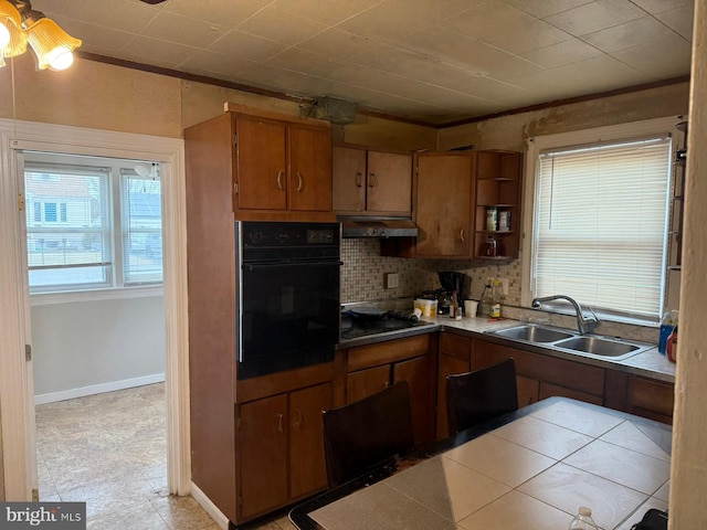 kitchen with sink, black appliances, and decorative backsplash