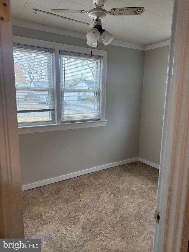 unfurnished room with ceiling fan, crown molding, and a wealth of natural light