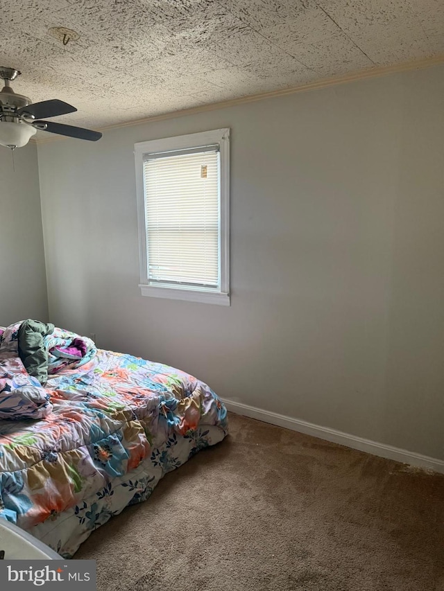 unfurnished bedroom featuring a textured ceiling, carpet flooring, and ceiling fan