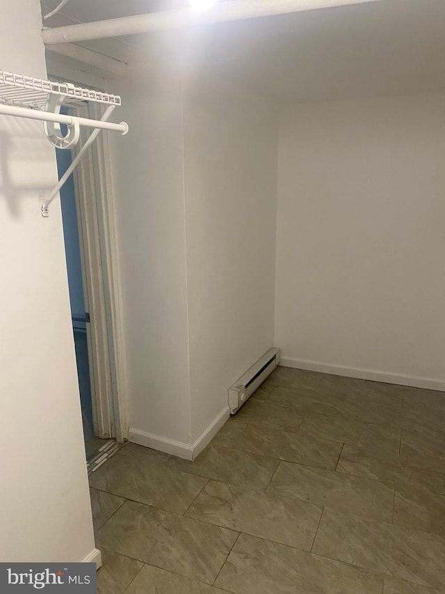 walk in closet with a baseboard radiator