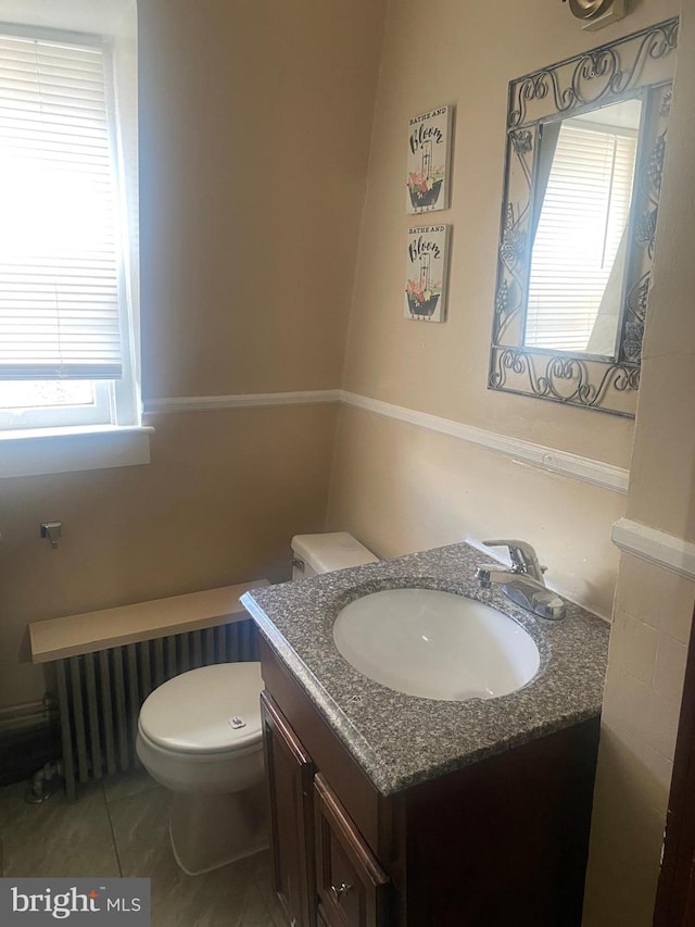 bathroom with vanity, tile patterned flooring, and toilet