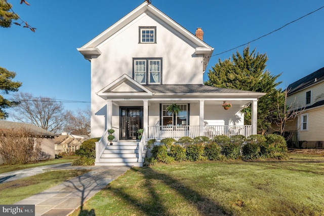 view of front of house featuring french doors, a chimney, stucco siding, covered porch, and a front yard