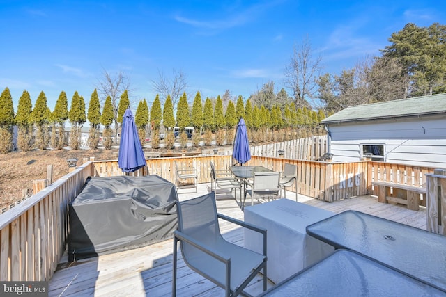 deck with outdoor dining area and fence