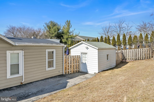 exterior space featuring fence and an outbuilding