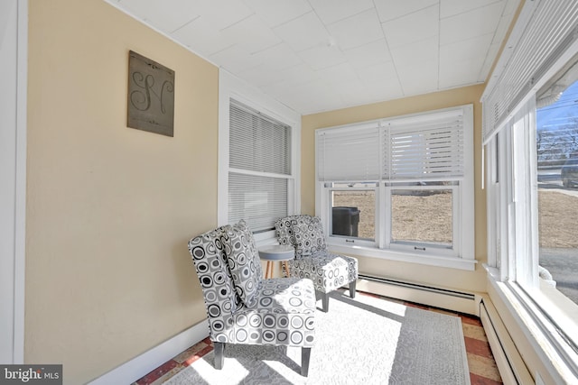 sunroom / solarium featuring a baseboard heating unit