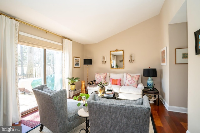 living room featuring vaulted ceiling and dark hardwood / wood-style floors