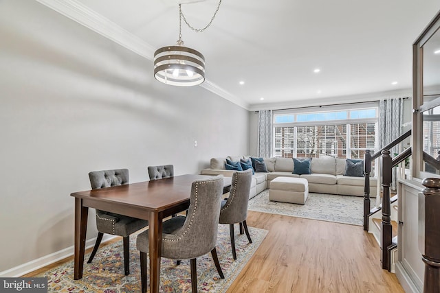 dining space with light wood-style floors, baseboards, ornamental molding, and recessed lighting