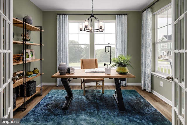 office space with an inviting chandelier and dark wood-type flooring