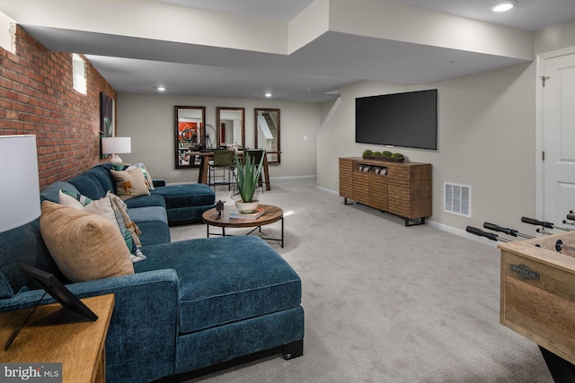 carpeted living room with brick wall