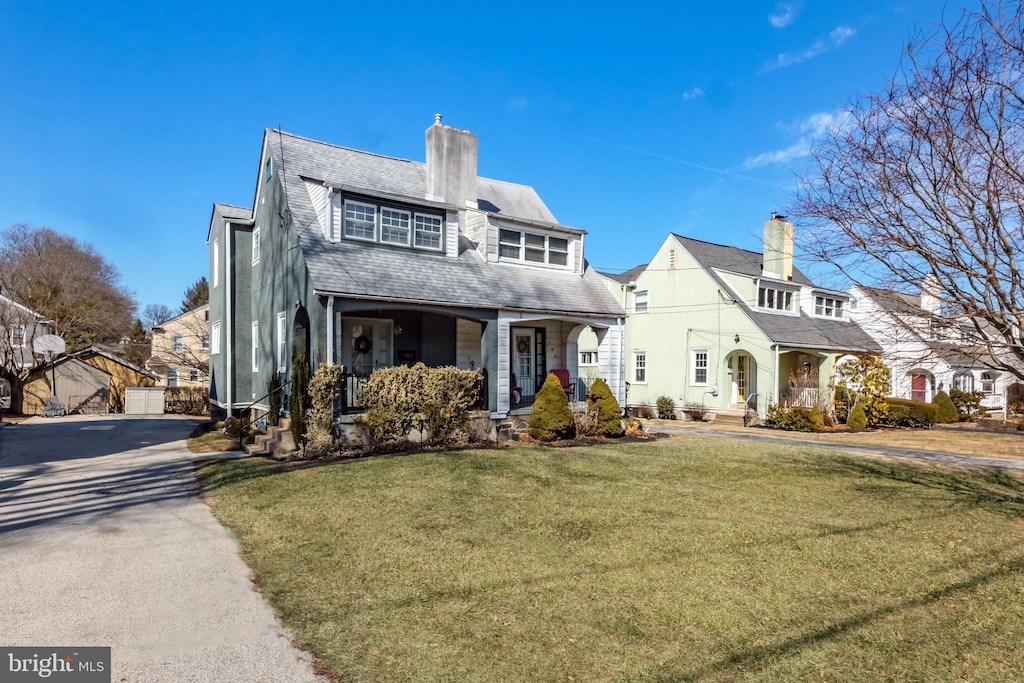 view of front of house with a front lawn and a porch