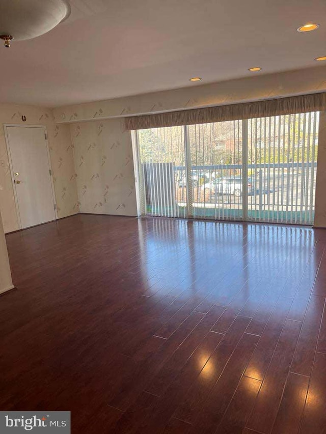 unfurnished room featuring dark wood-type flooring