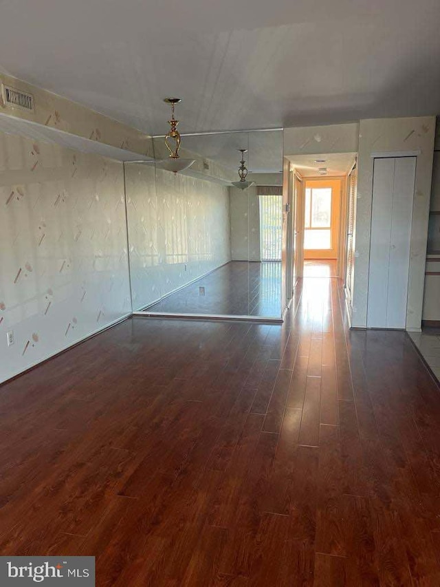 spare room featuring dark wood-type flooring