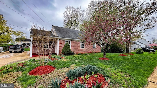 view of property exterior with a yard and brick siding