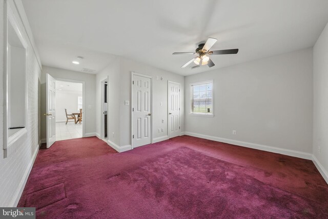 unfurnished bedroom with carpet, visible vents, baseboards, and ceiling fan