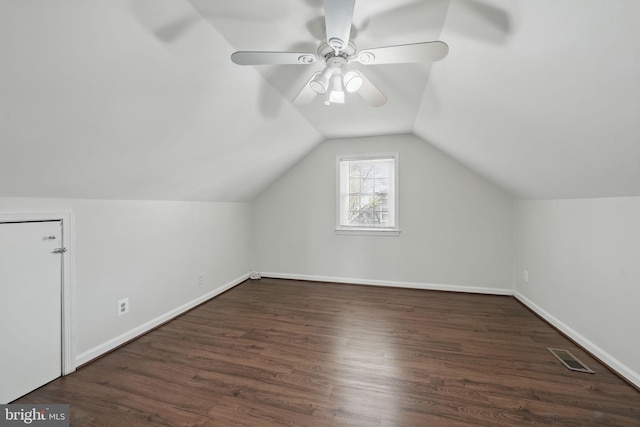 additional living space with visible vents, baseboards, ceiling fan, vaulted ceiling, and wood finished floors