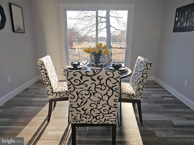 dining room featuring baseboards and dark wood finished floors