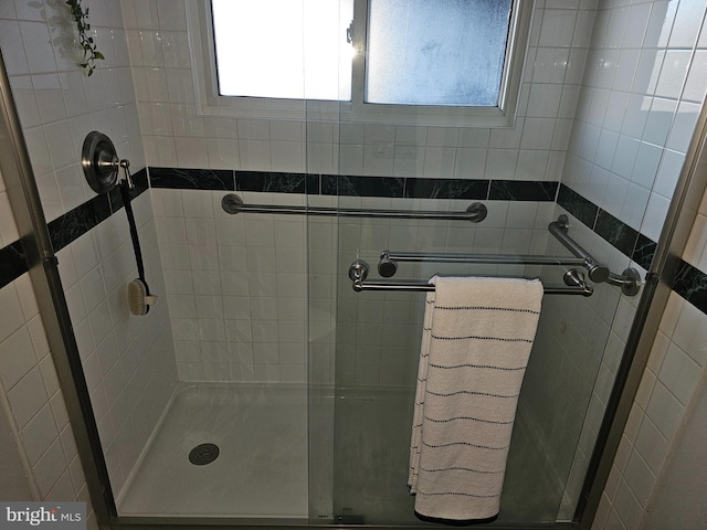 full bathroom featuring a stall shower and a wealth of natural light