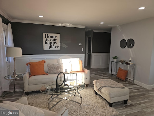 living room featuring a wainscoted wall, crown molding, and wood finished floors