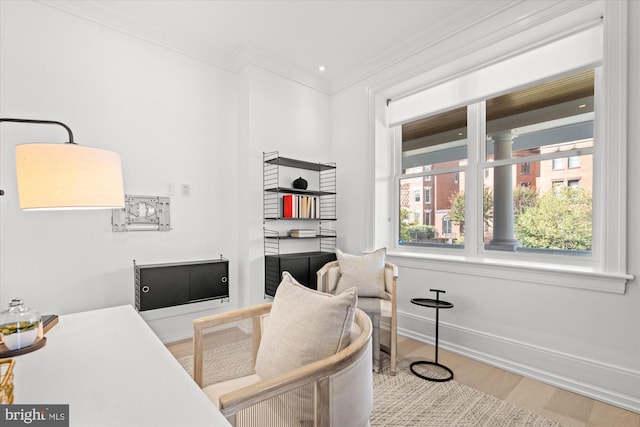 office space featuring wood-type flooring, a wealth of natural light, and crown molding