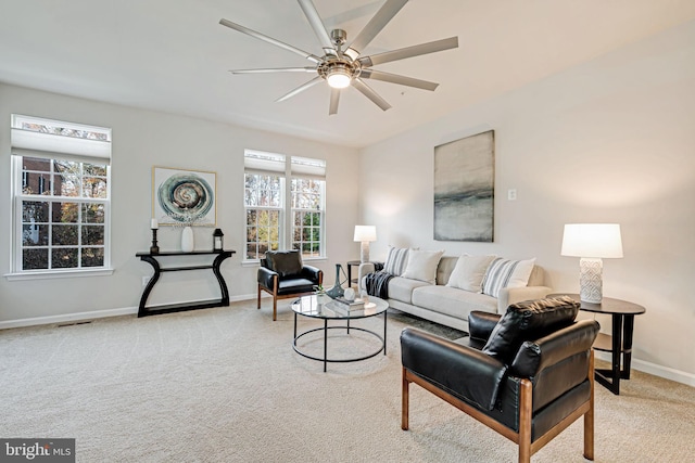 carpeted living room with ceiling fan