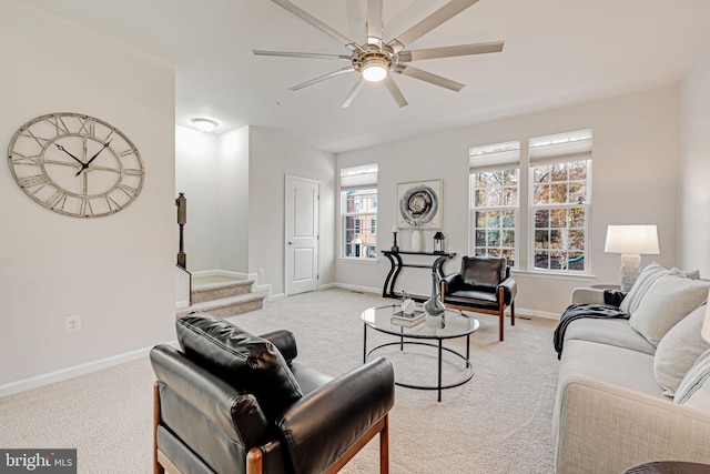 carpeted living room with ceiling fan