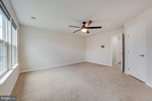 carpeted empty room featuring ceiling fan