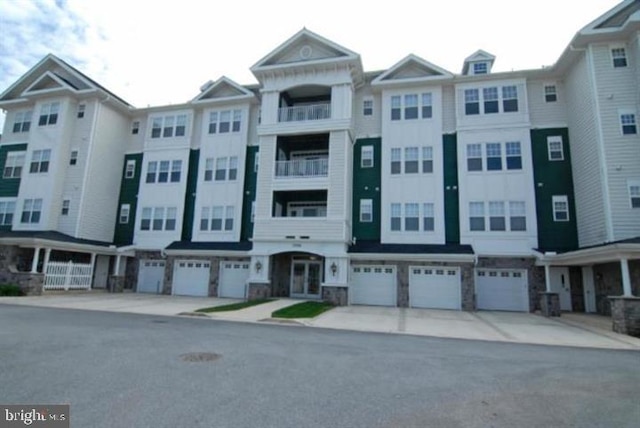 view of building exterior with driveway and an attached garage