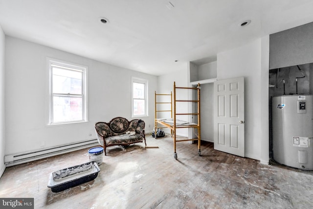 sitting room with a baseboard heating unit and water heater