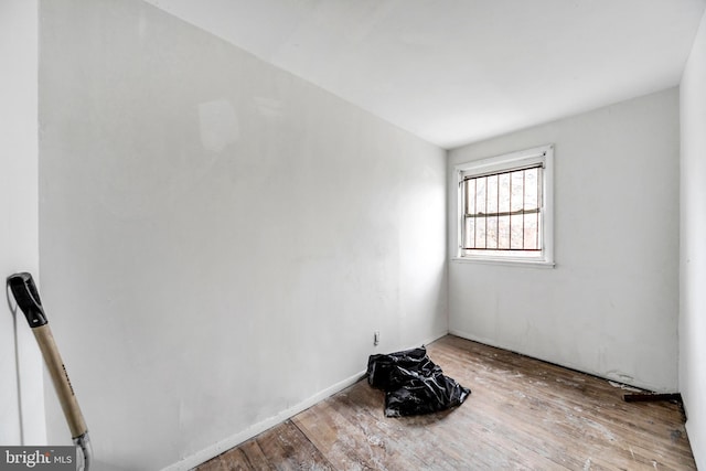 unfurnished room with wood-type flooring