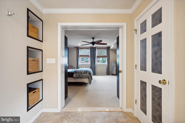 hallway featuring light carpet, baseboards, and ornamental molding