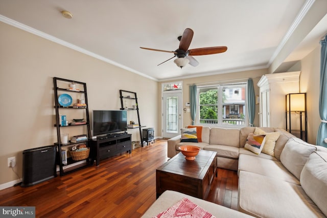 living room with baseboards, wood-type flooring, a ceiling fan, and crown molding