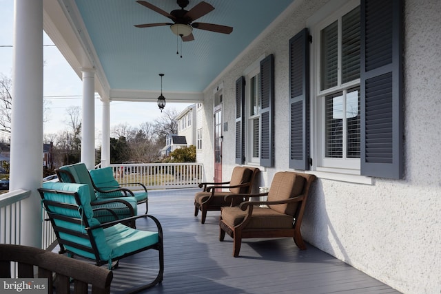 wooden terrace with ceiling fan and a porch