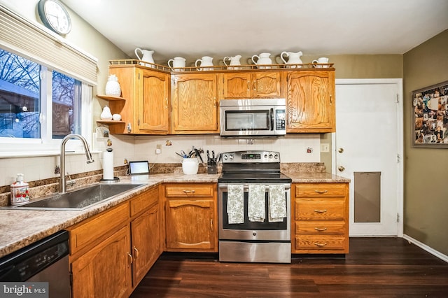 kitchen featuring appliances with stainless steel finishes, sink, tasteful backsplash, and dark hardwood / wood-style floors