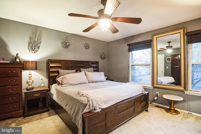 carpeted bedroom with ceiling fan