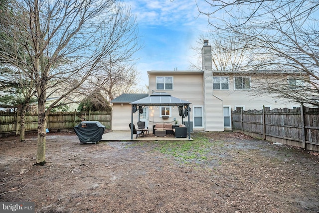 back of property with a patio area, outdoor lounge area, and a gazebo