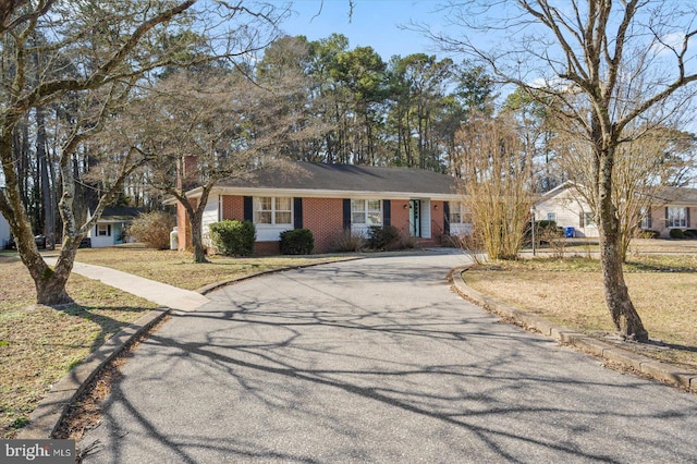 ranch-style house with a front lawn