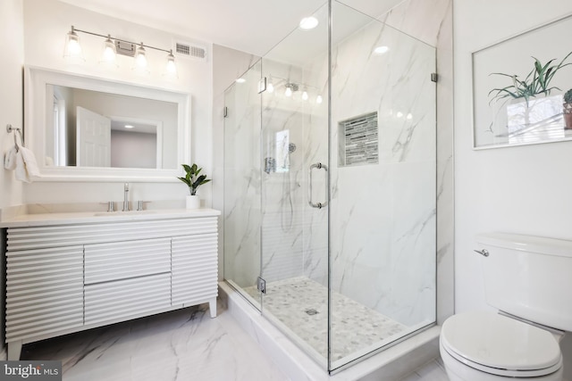 bathroom with an enclosed shower, vanity, and toilet