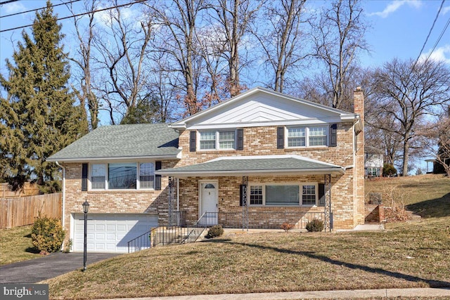 view of front of home with a front lawn and a garage