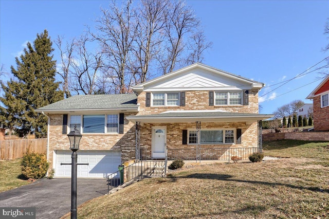 tri-level home with a garage and a front lawn