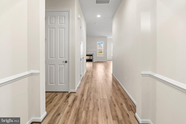 hall with light hardwood / wood-style floors